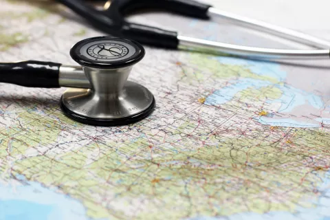 Stethoscope laying on top of a map 